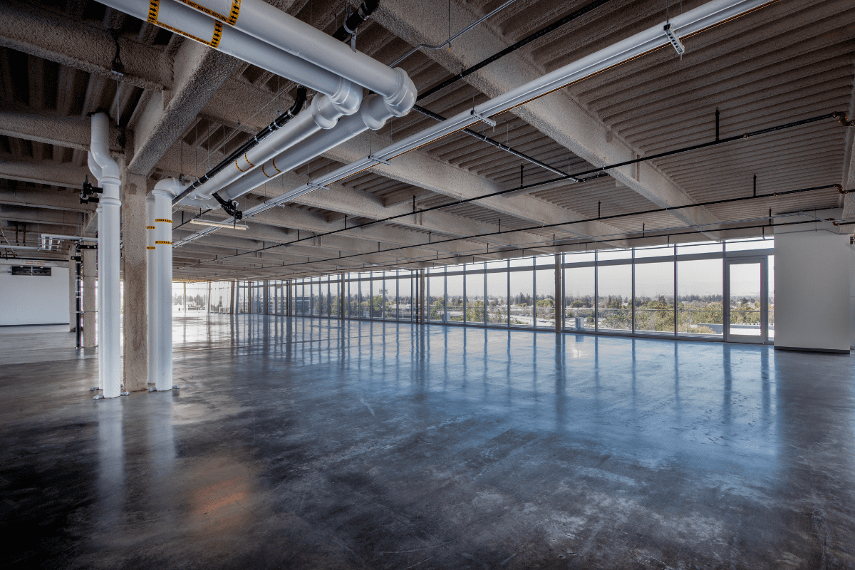 Empty industrial-style open office space.